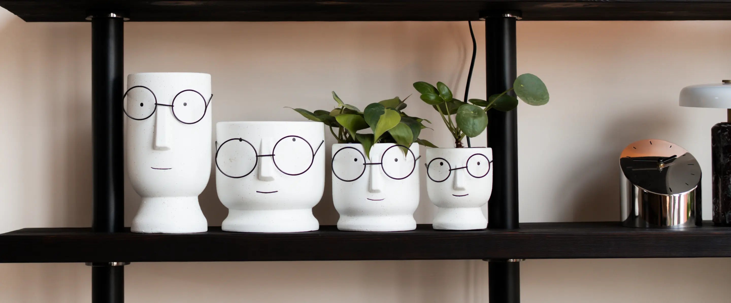 Jojo white ceramic planters in four sizes styled together on modern shelf