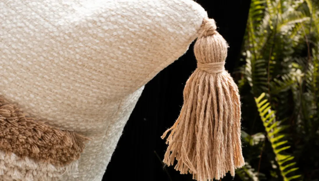 Detail shot of tassel corner on Kanso cushion cover showing artisanal finish