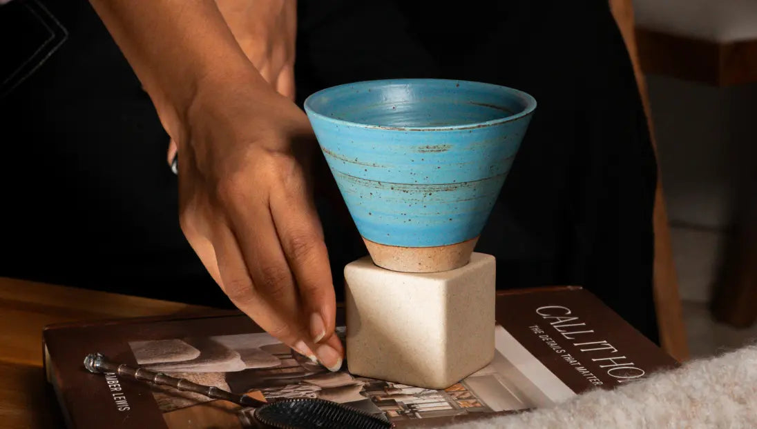 Turquoise ceramic coffee cup styled on table with warm natural textures