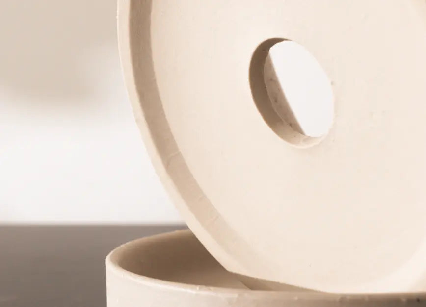 Drainage hole detail of the Kora Ceramic Planter shown with matching ceramic saucer base