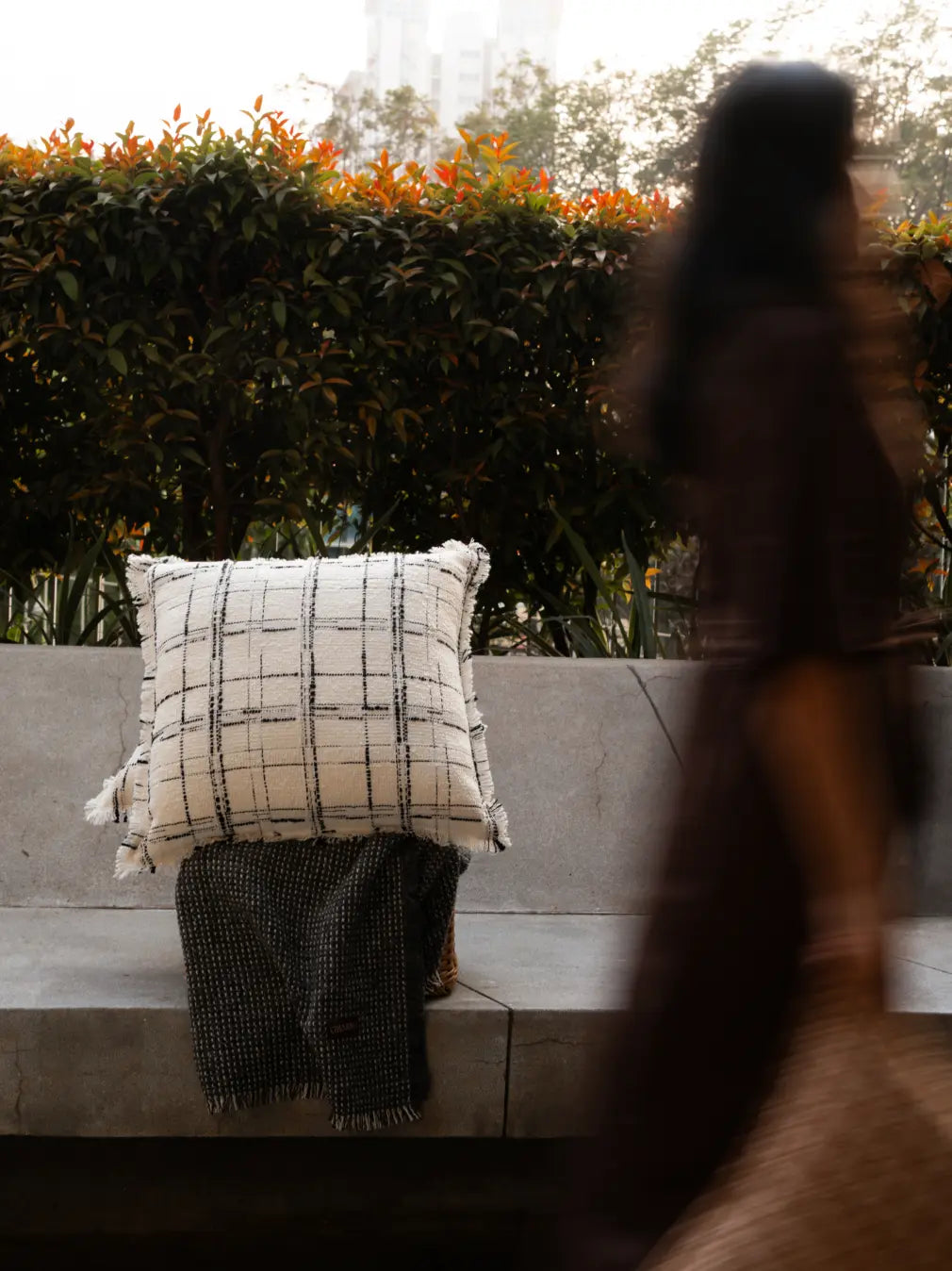 Lattice cushion cover styled on outdoor seating with calm, modern home decor feel.