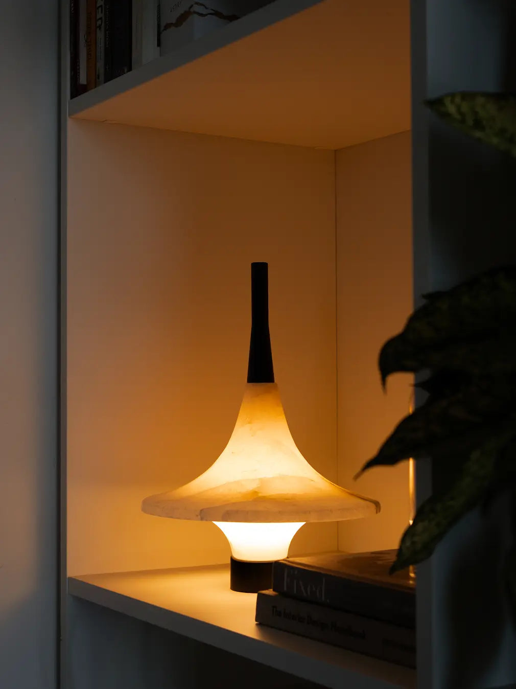Gharko modern marble table lamp styled on a shelf with warm light