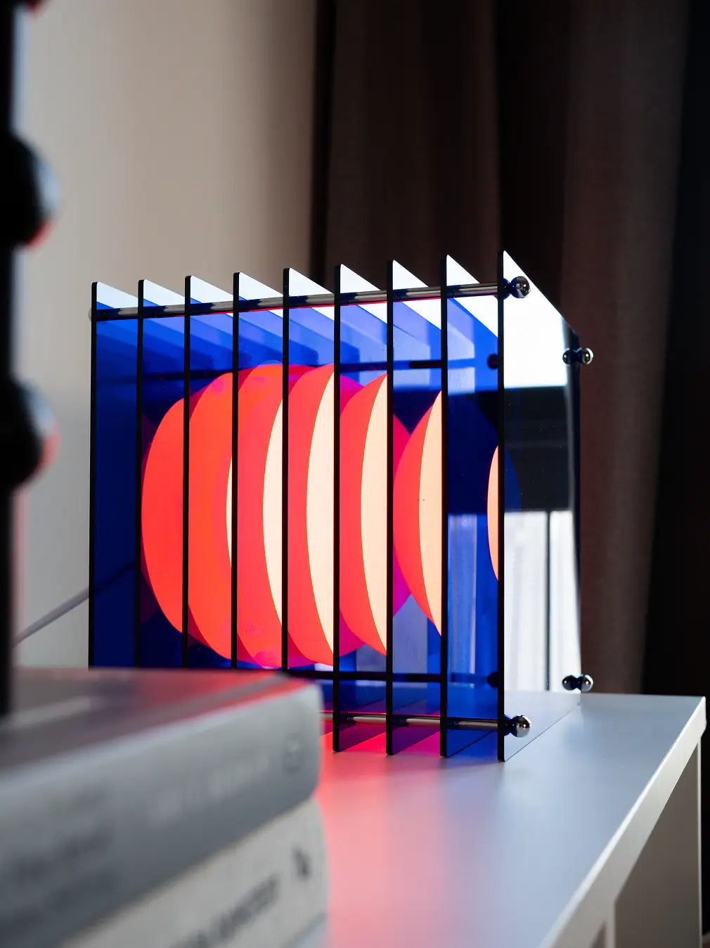 Sculptural blue table lamp with opal globe and layered light reflections