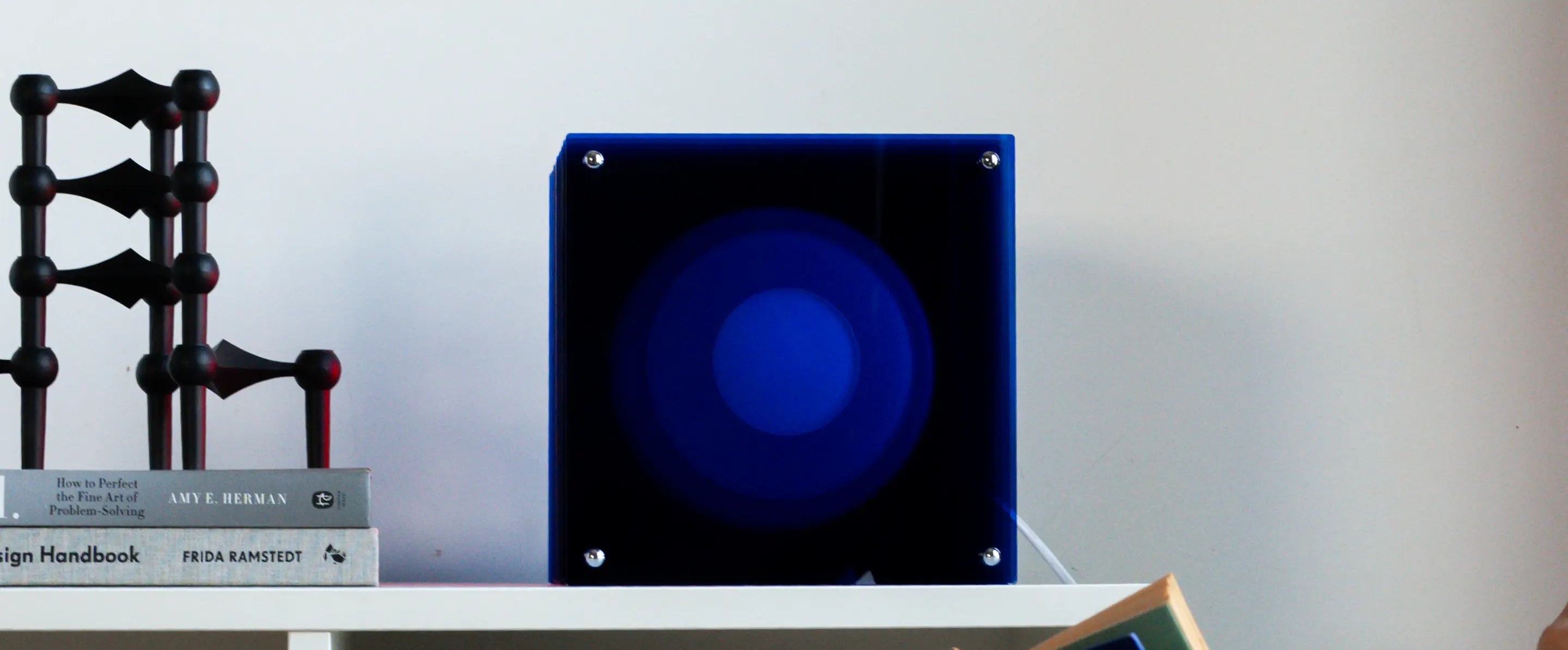 Front view of Lop Blue decorative table lamp with layered acrylic reflections