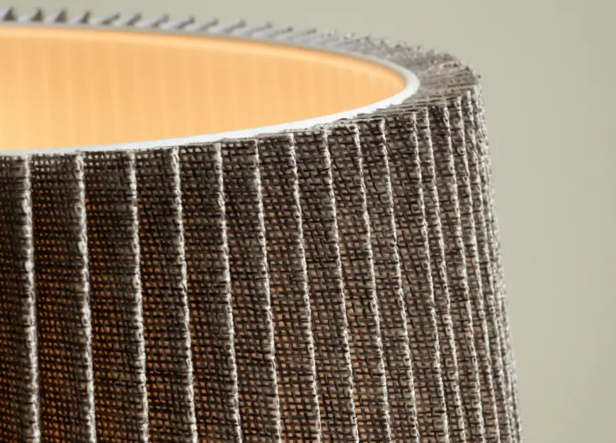 Close-up of a textured brown and grey fabric roll of Mati Ceramic table Lamp on a neutral background