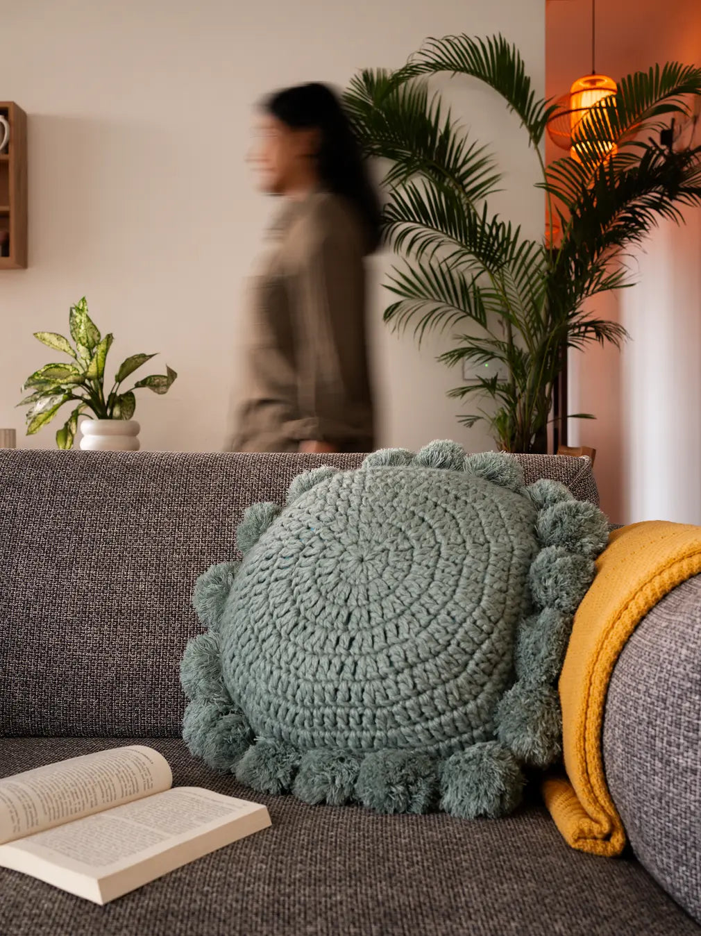 Nimbus Round Cushion Turquoise Blue on grey sofa with yellow throw