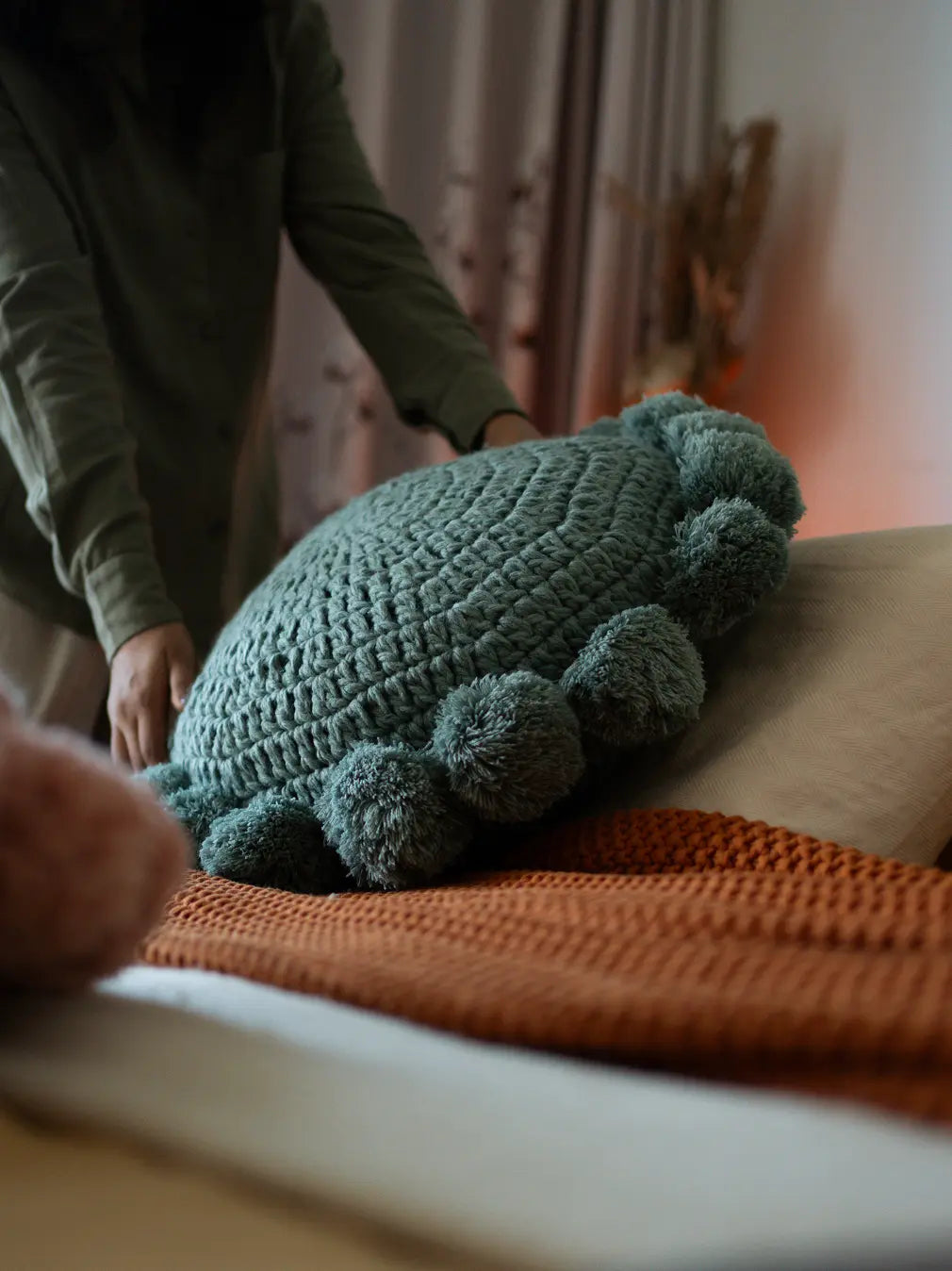 Styling Nimbus Round Cushion Turquoise Blue on bed with mustard blanket