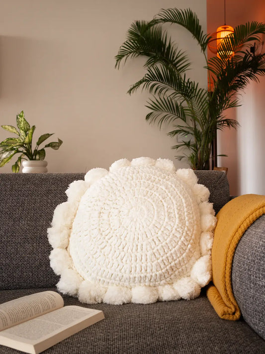 Gharko White textured pillow on a gray sofa with a plant in the background