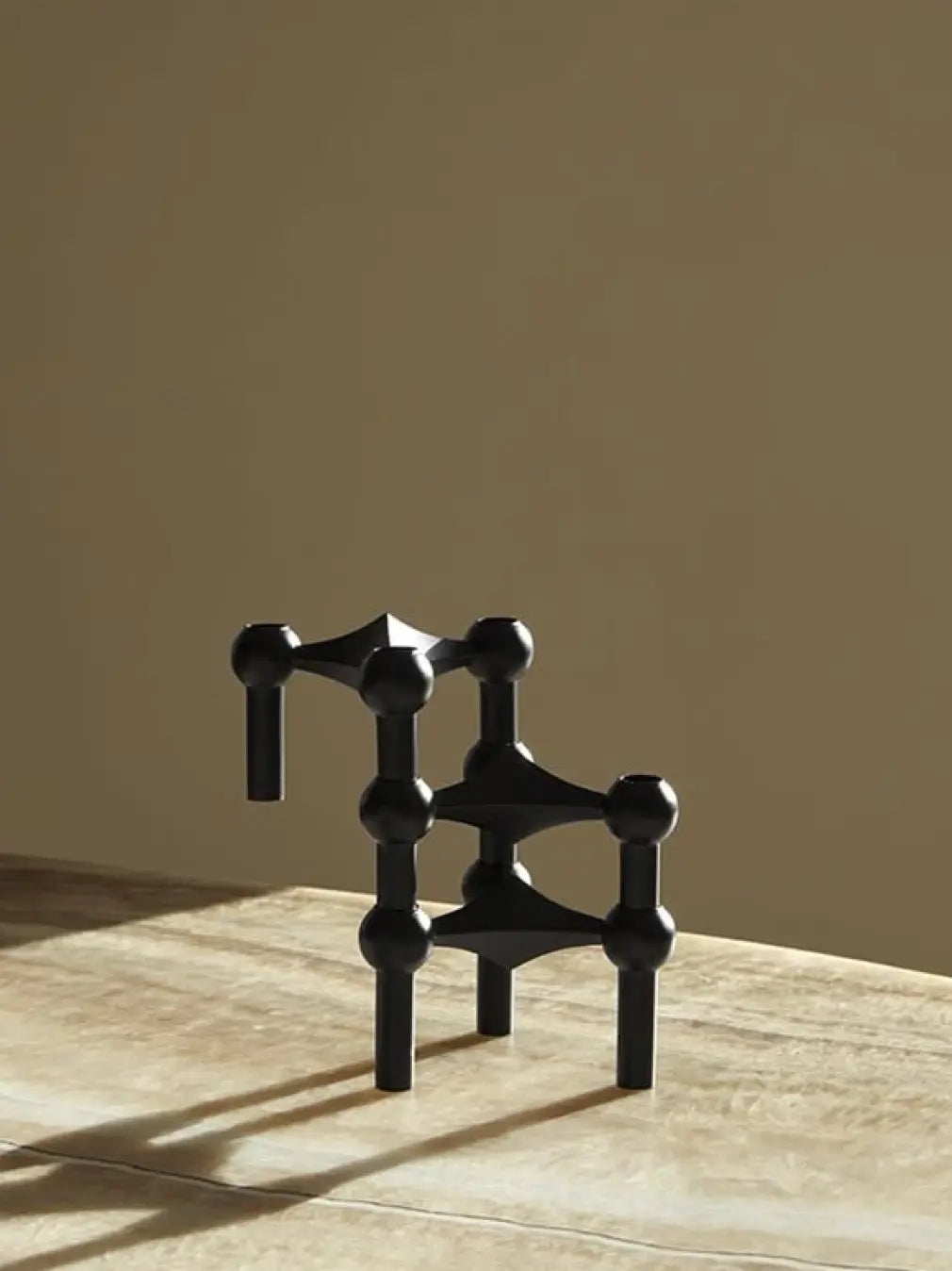 Stackable black candle stand styled on modern tabletop decor