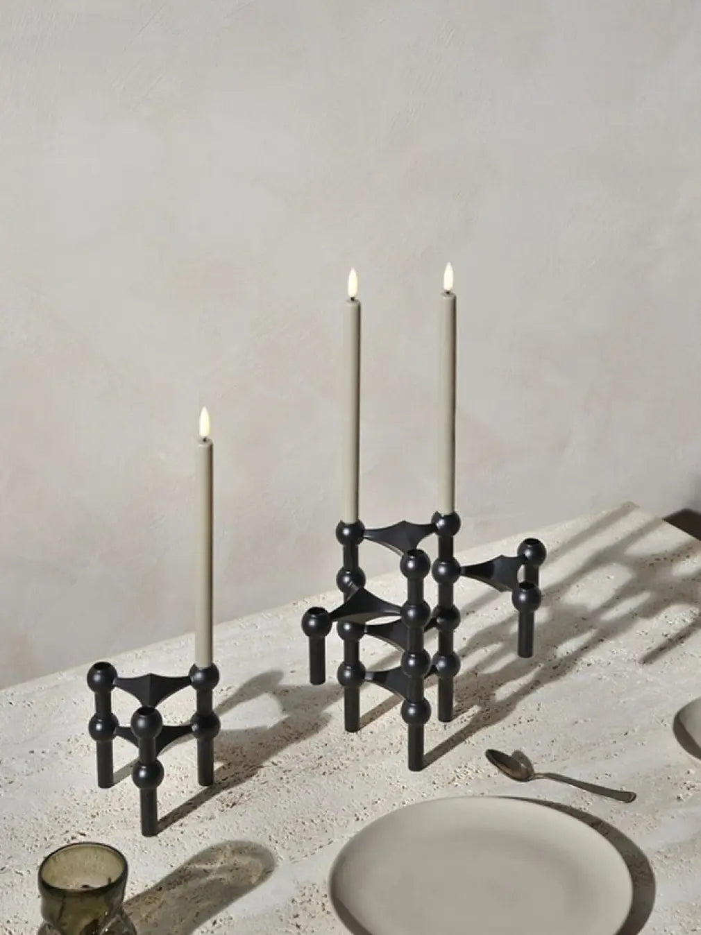 Modular black taper candle holders styled for modern dining table decor