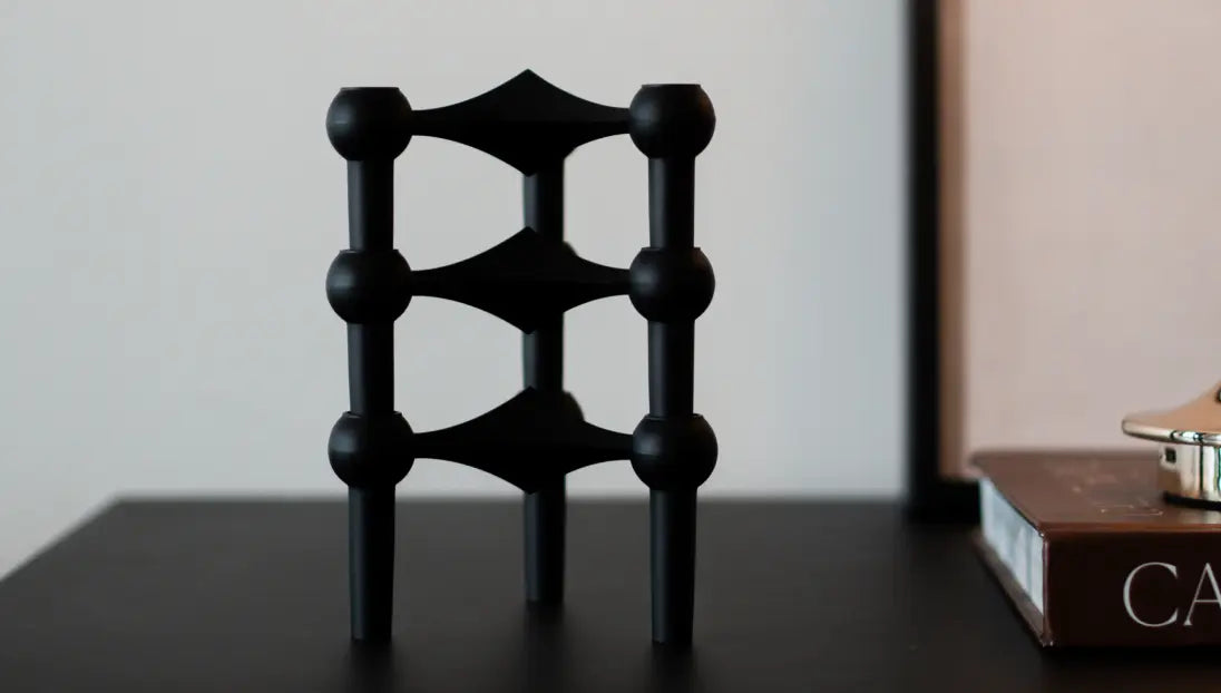 Sculptural Node black candle holder styled on minimalist bedside console