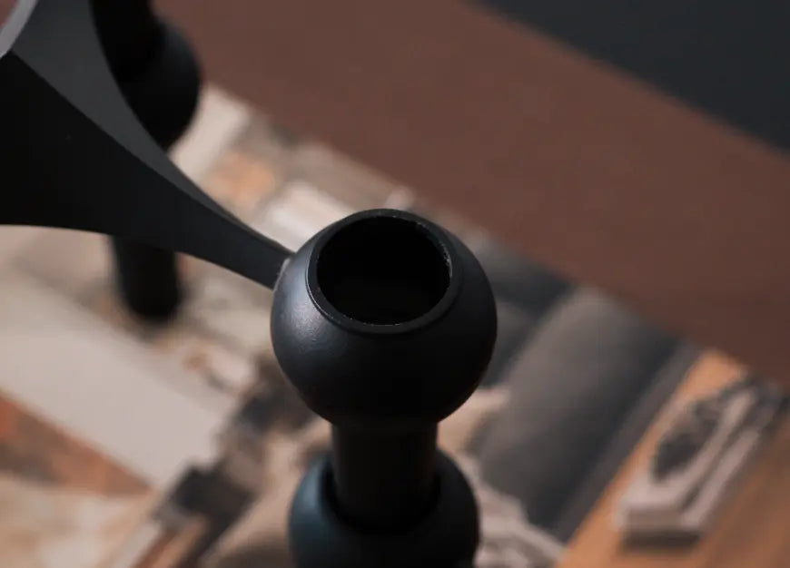Close-up of matte black taper candle holder with smooth sculptural metal finish