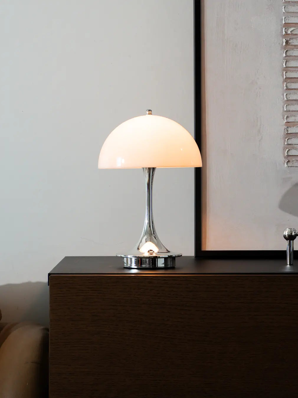 Modern cordless mushroom table lamp with glossy acrylic shade and warm light