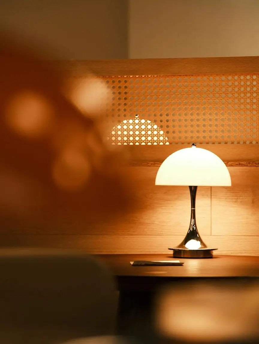 Modern acrylic mushroom table lamp with soft warm LED glow on shelf