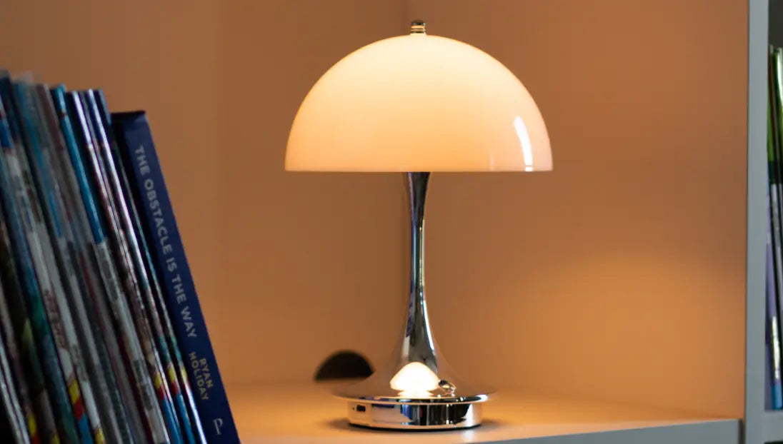 Modern mushroom table lamp with warm LED light beside books