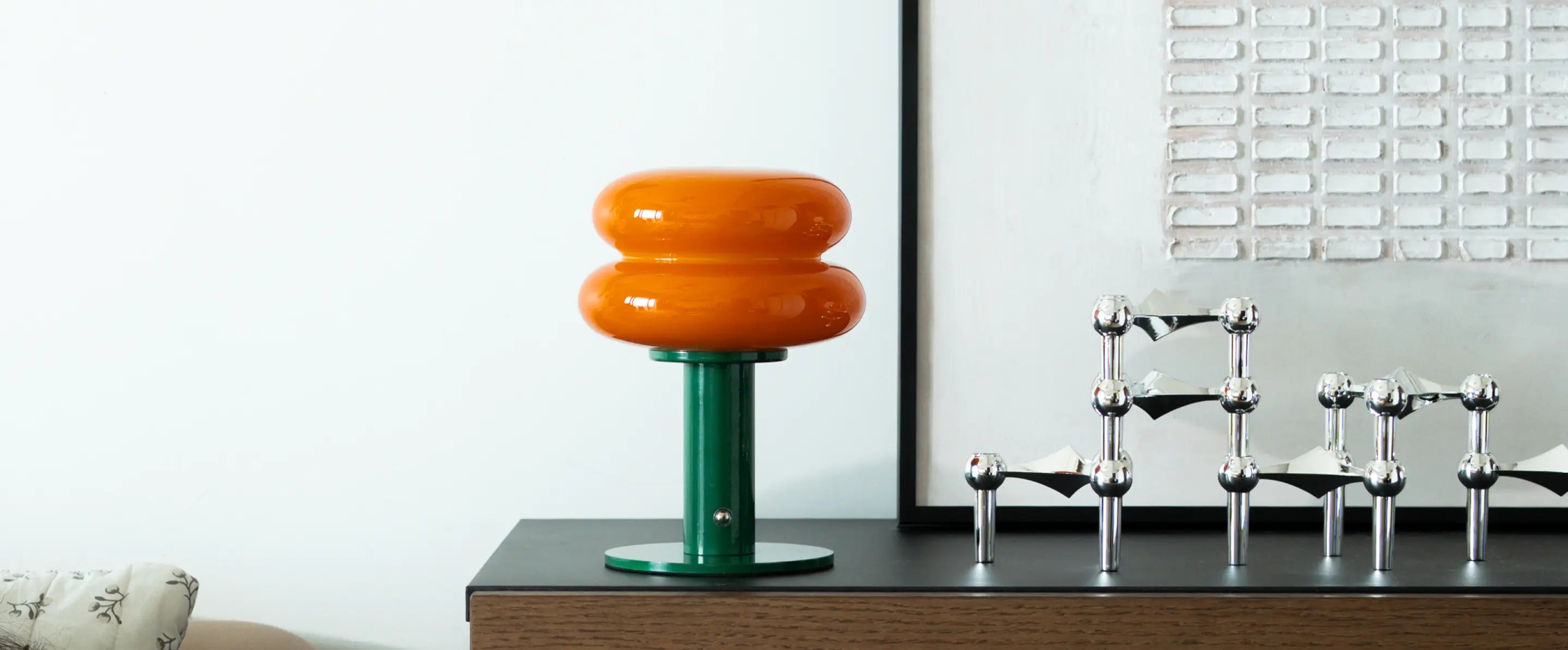 Orbit Orange portable table lamp with sculptural glass design and metal base