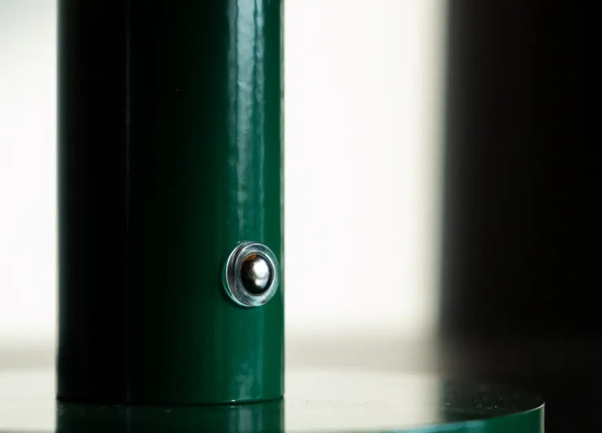 Touch switch detail of Orbit Orange portable table lamp with metal green base