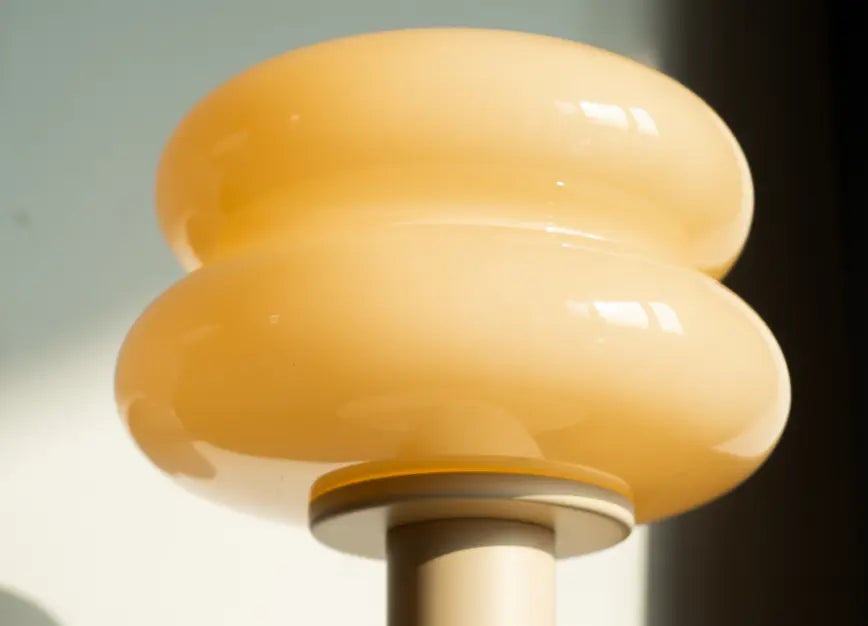 Sculptural glass shade of modern Orbit Yellow wireless table lamp close-up
