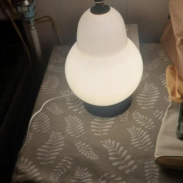 White Pear lamp review on a table with a leaf patterned tablecloth