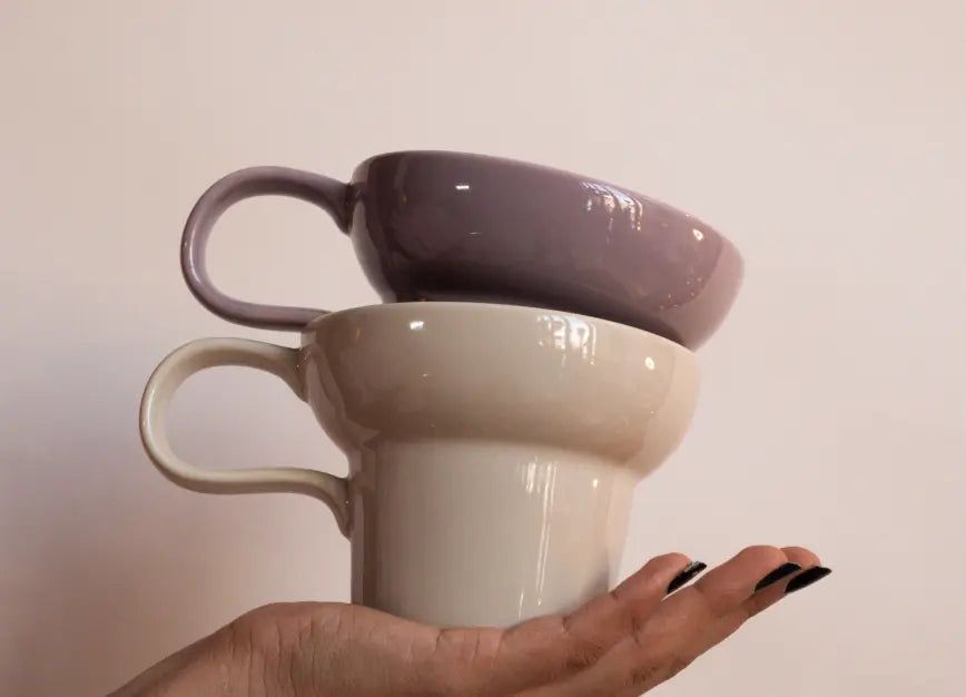 Pico ceramic coffee mug held in hand, highlighting balanced design and elegant profile