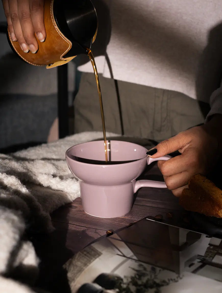 Coffee being poured into lilac Pico ceramic coffee mug during a cozy coffee moment
