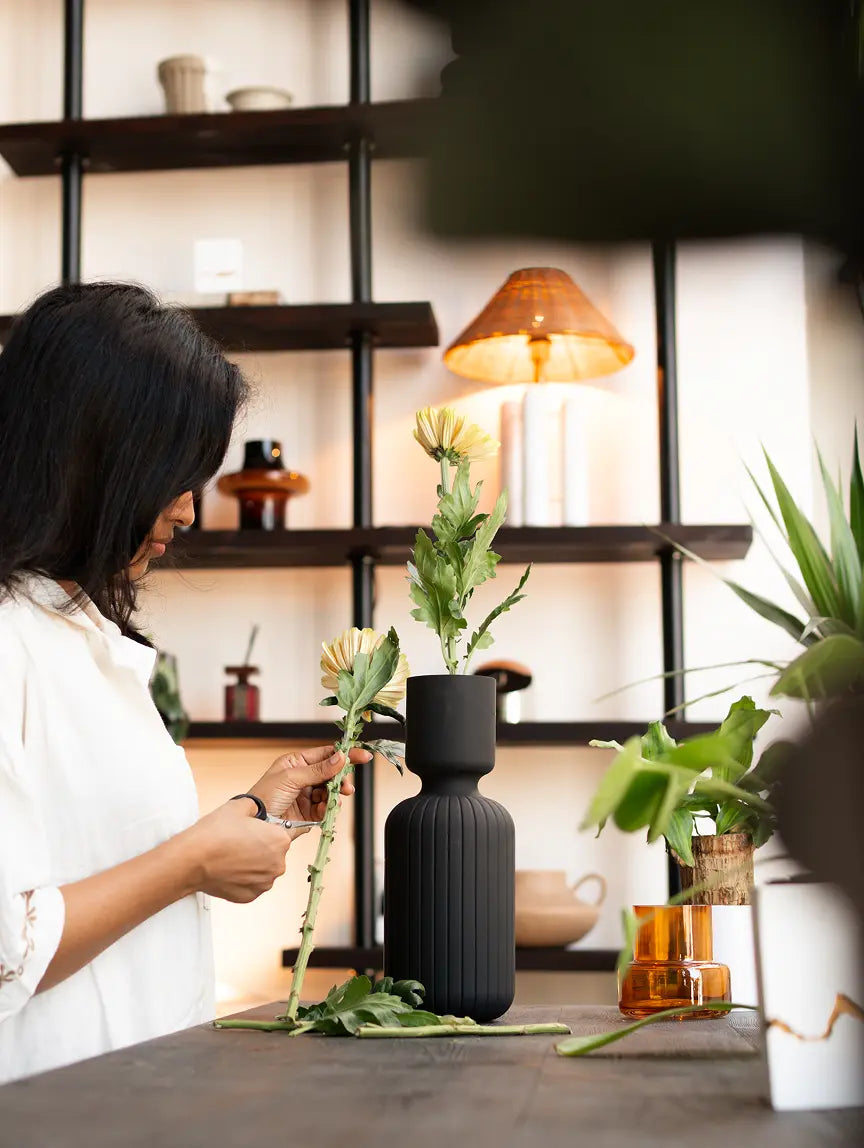 Ridge Glass Vase styled with flowers in a cozy room setup, adding modern elegance to home décor.