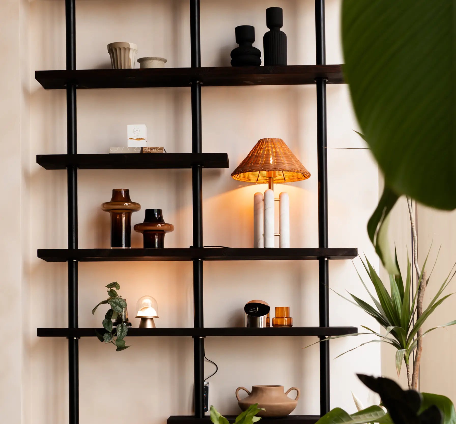 Decorative shelf with various items against a neutral wall