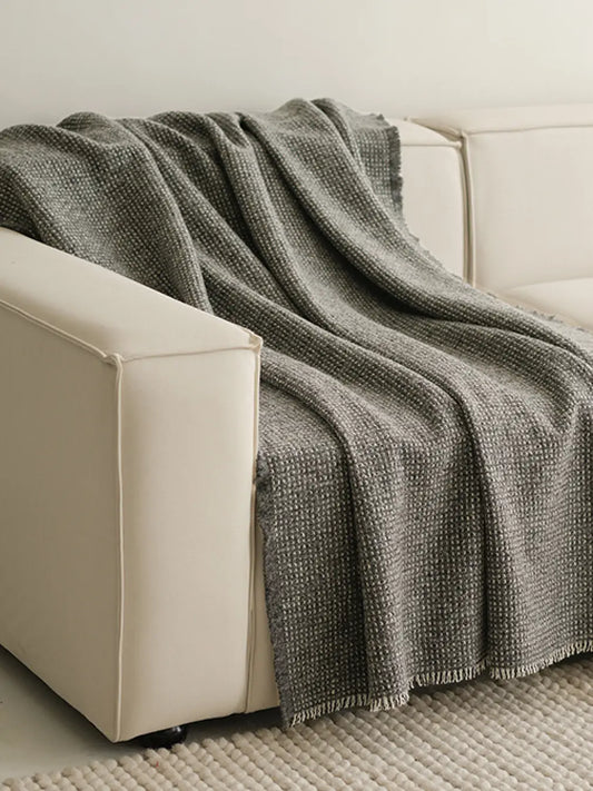 Slate Angora wool throw blanket draped over white sofa in modern living room
