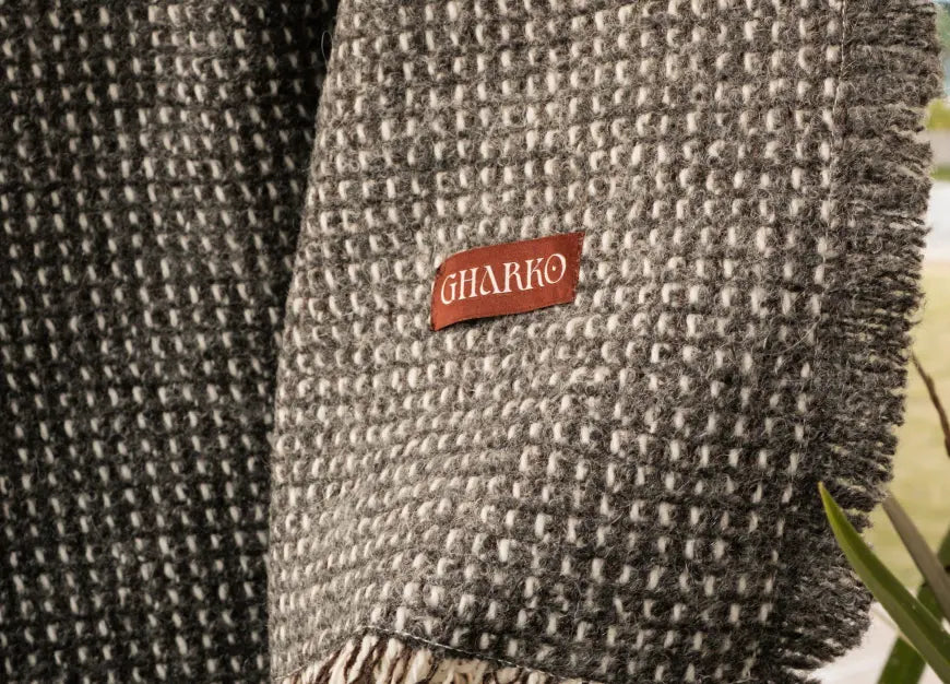 Close-up of Slate Angora throw blanket showing jacquard weave and tasselled edge