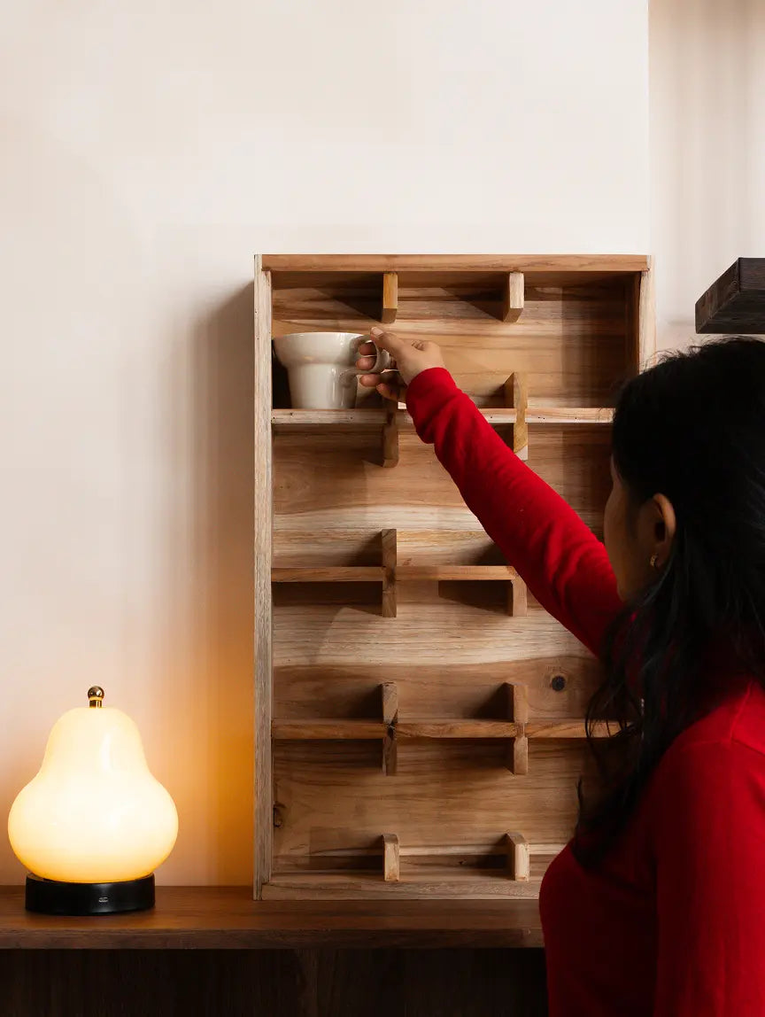 Woman placing mug on teak wood coffee cup shelf wall mounted mug rack