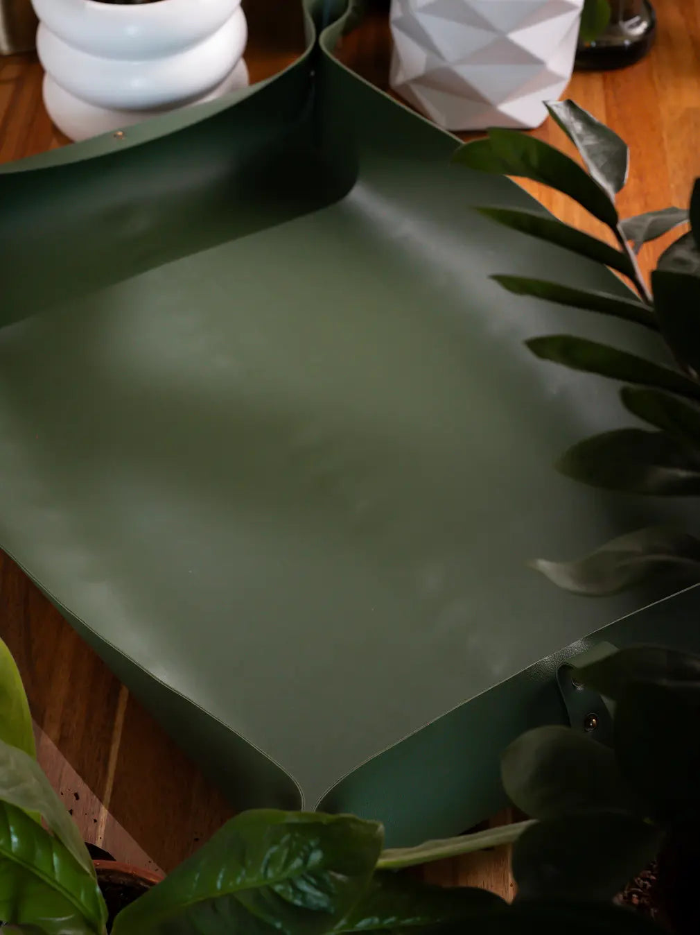 Solum Olive potting mat laid flat, smooth vegan leather surface for clean repotting