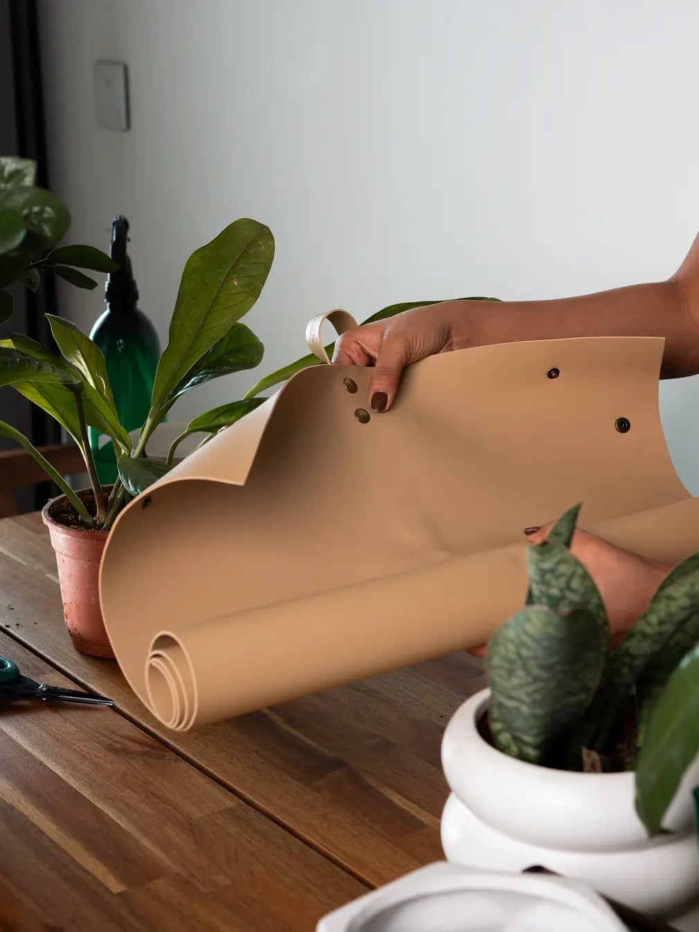 Unrolling Solum tan potting mat, showing flexible, space-saving design