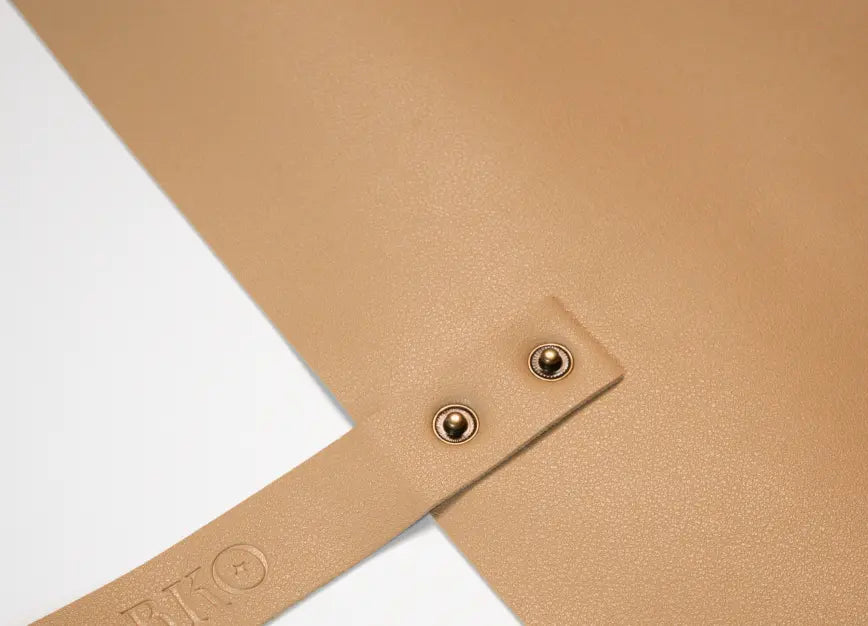 Textured faux leather potting mat surface with metal snap details