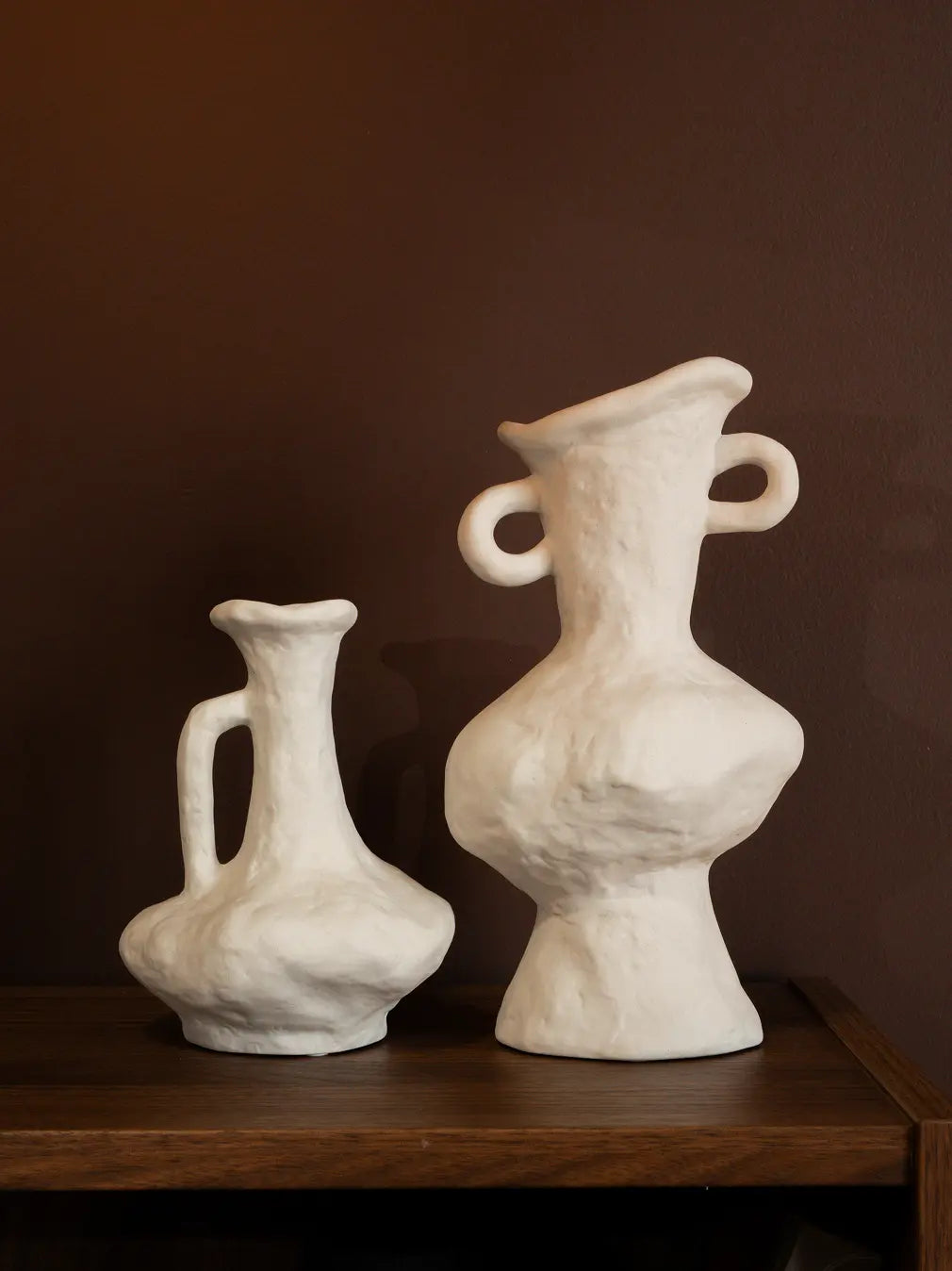 Suki Classic Ceramic Vase size comparison showing sculptural white ceramic vases on wooden surface.