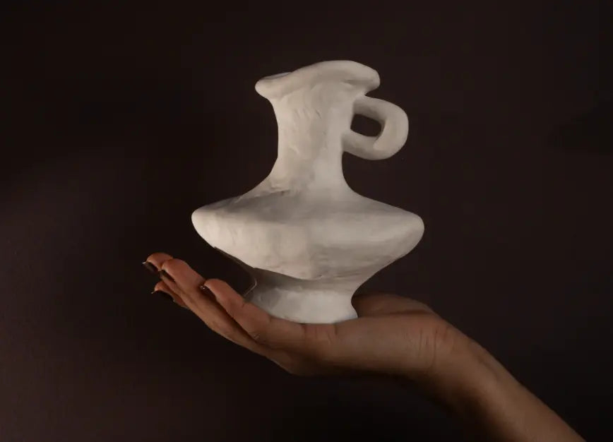 Suki Mini Ceramic Vase displayed in hand, highlighting its compact size, balanced weight, and ceramic texture.