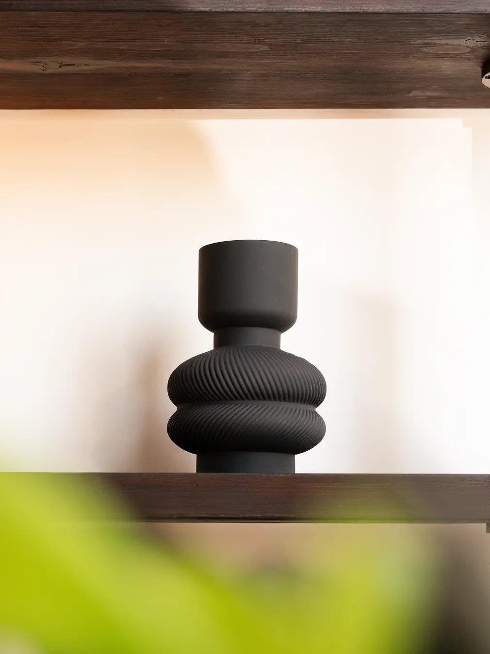 Torus Glass Vase in modern black sculptural glass flower vase on wooden shelf for interior styling.