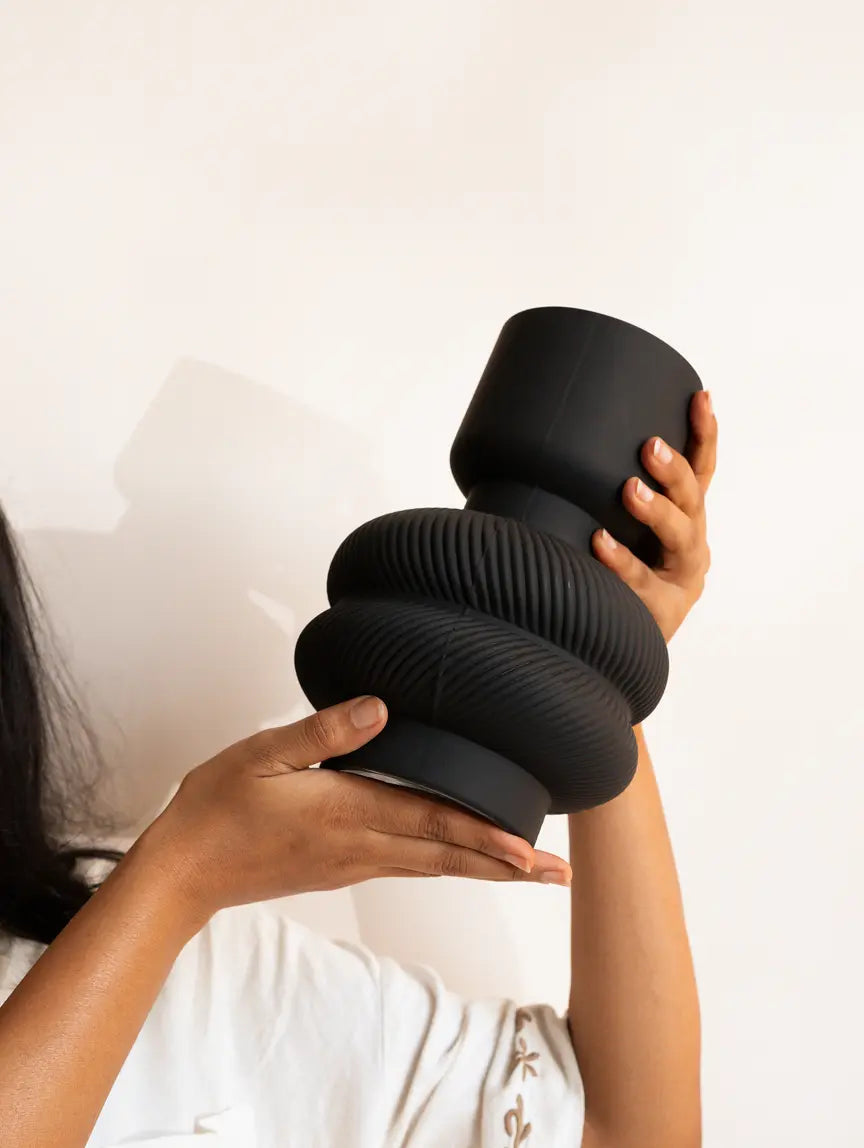 Torus Glass Flower Vase with premium matte black glass vase held in hands for modern home styling.