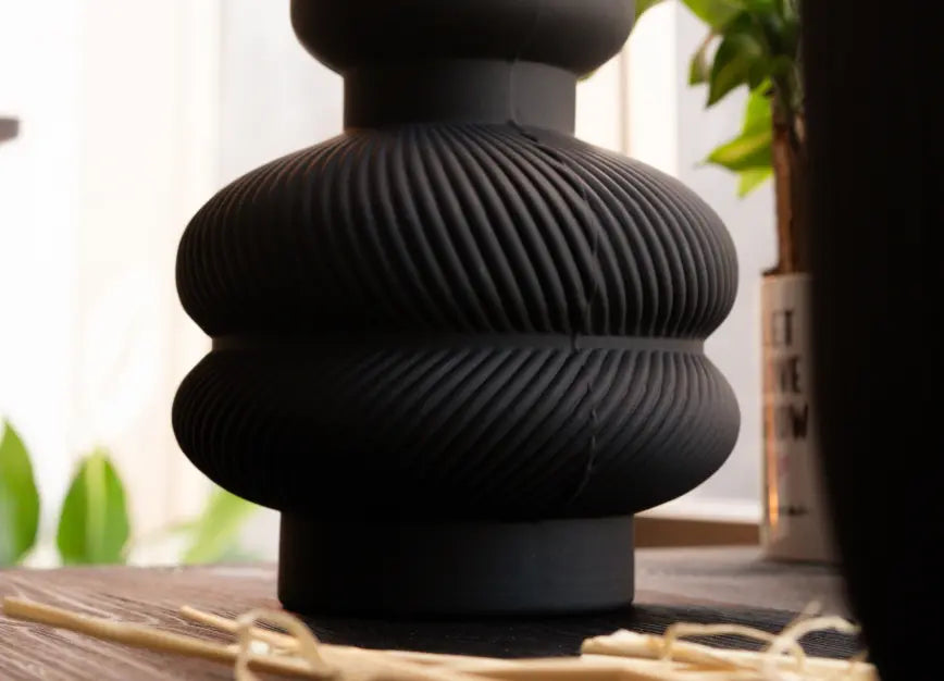 Ribbed base of Torus Glass Vase showing modern sculptural matte black glass design.