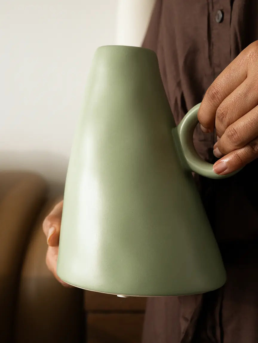 Close-up of circular handle on decorative modern ceramic flower vase.