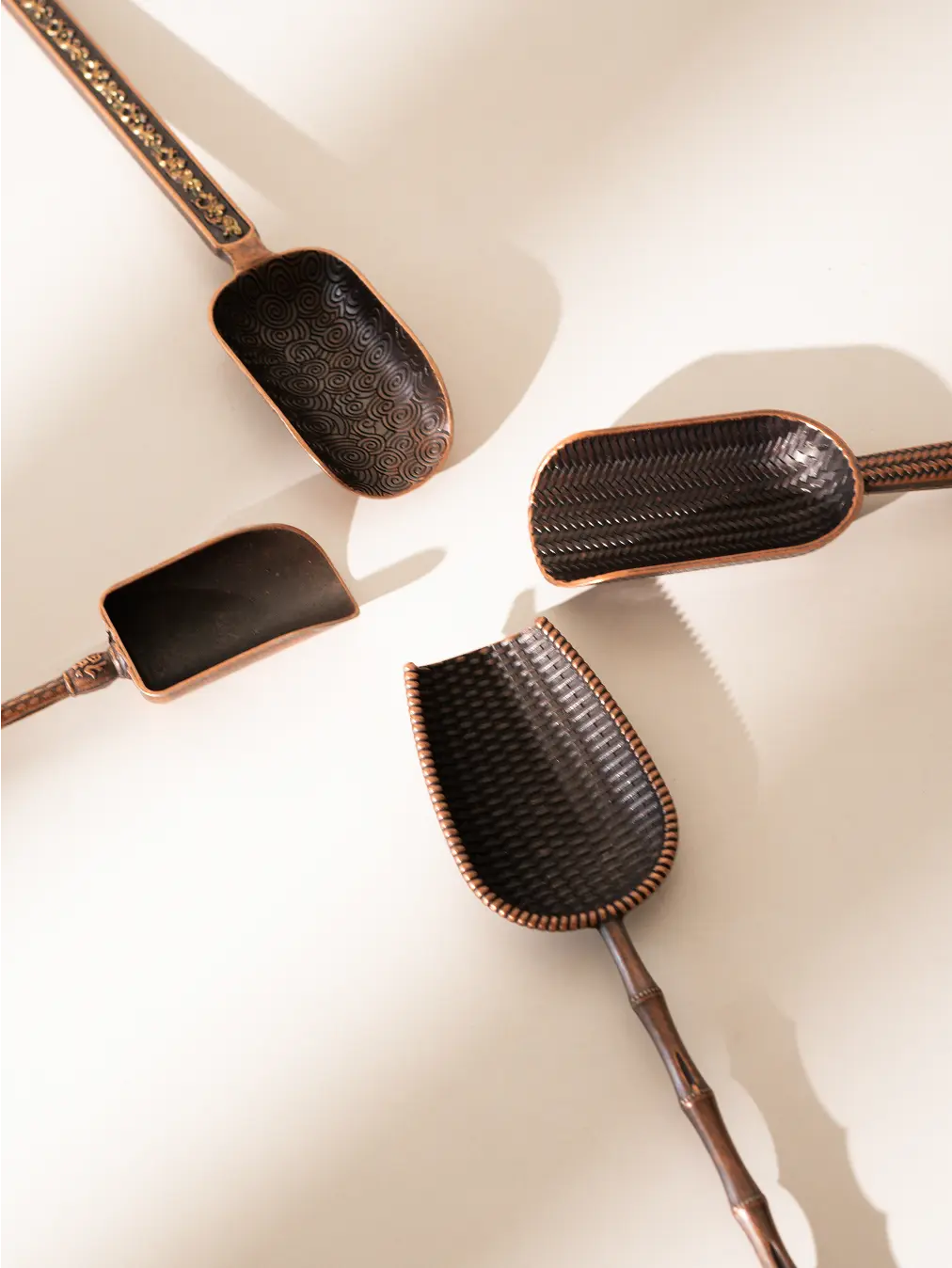 Flat-lay of four Vintage Spoons on a white background, showcasing unique patterns.
