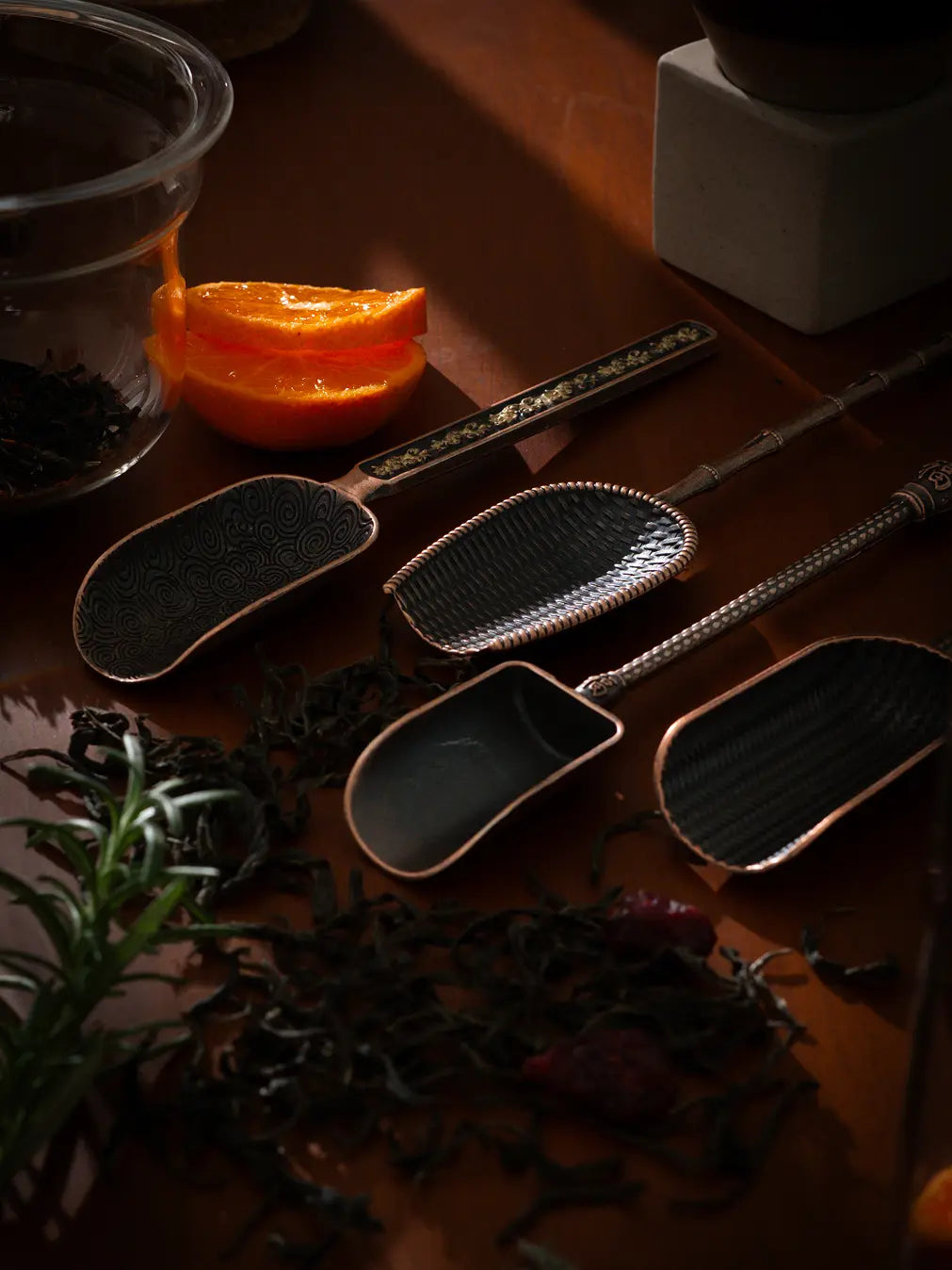 Vintage Spoon set arranged with dried tea leaves highlighting the elegant antique finish.