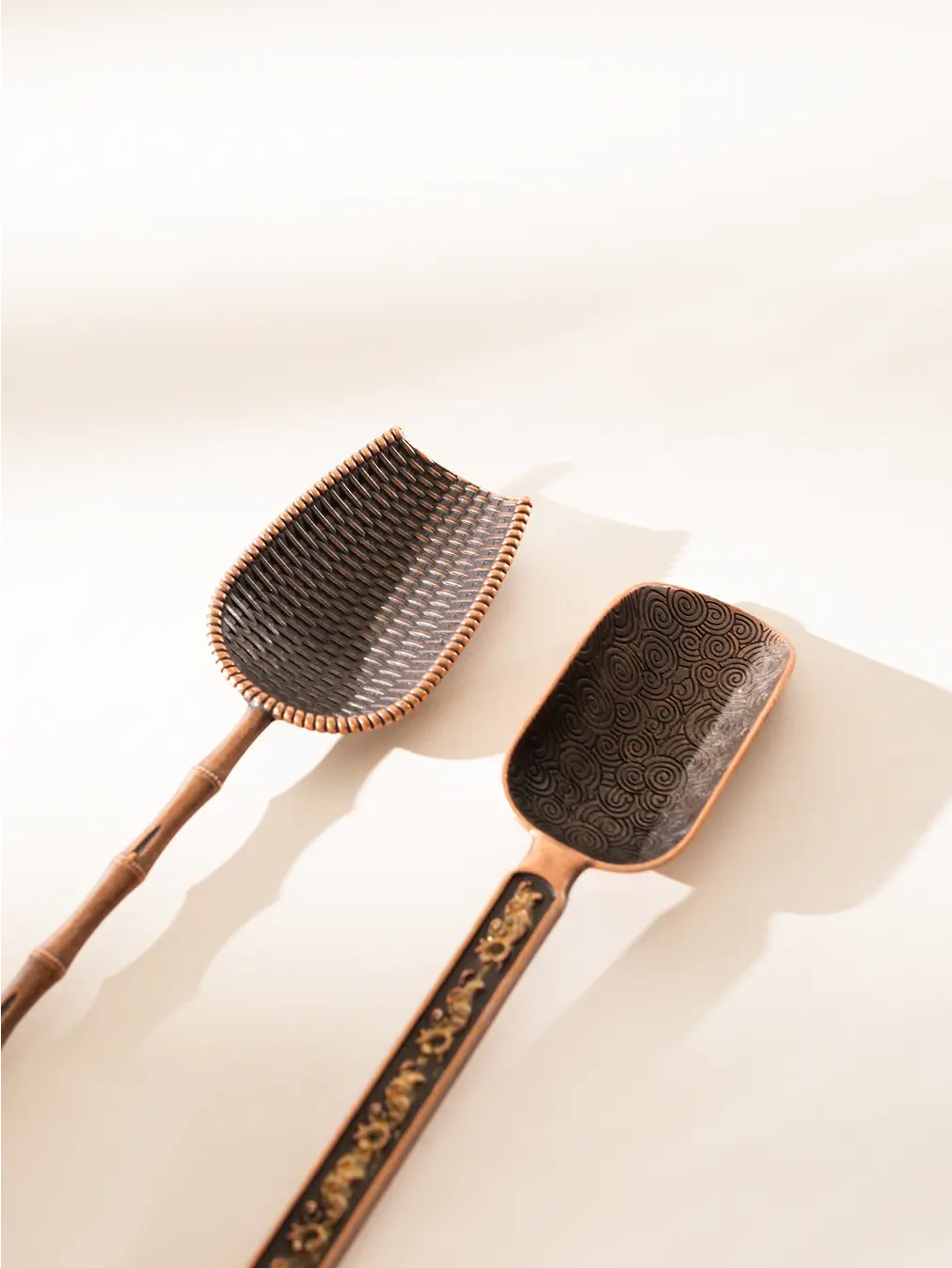 Close-up of two Vintage Spoons with engraved handles, under soft natural light.