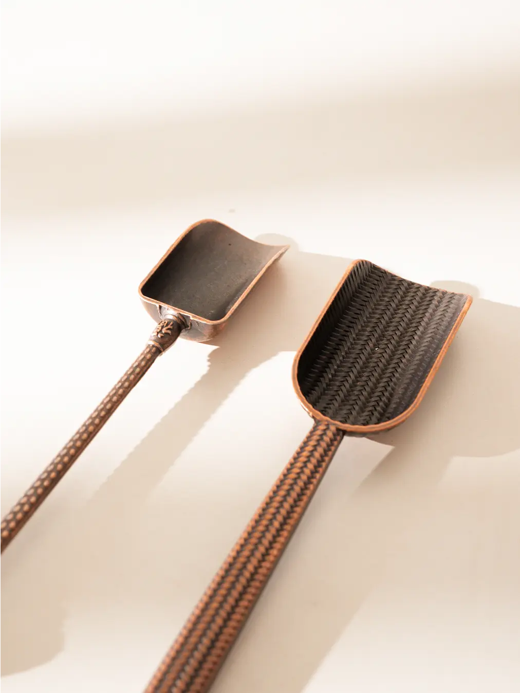 Two Vintage Spoons with detailed patterns, displayed on a white background.
