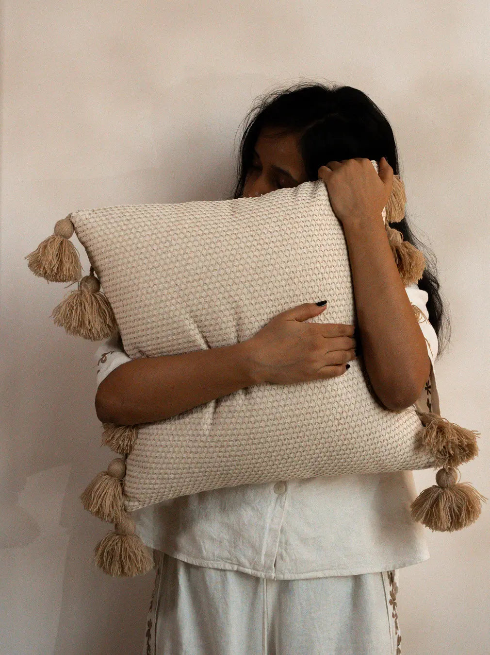 Cotton linen waffle cushion cover close-up showing textured weave and tassel detail