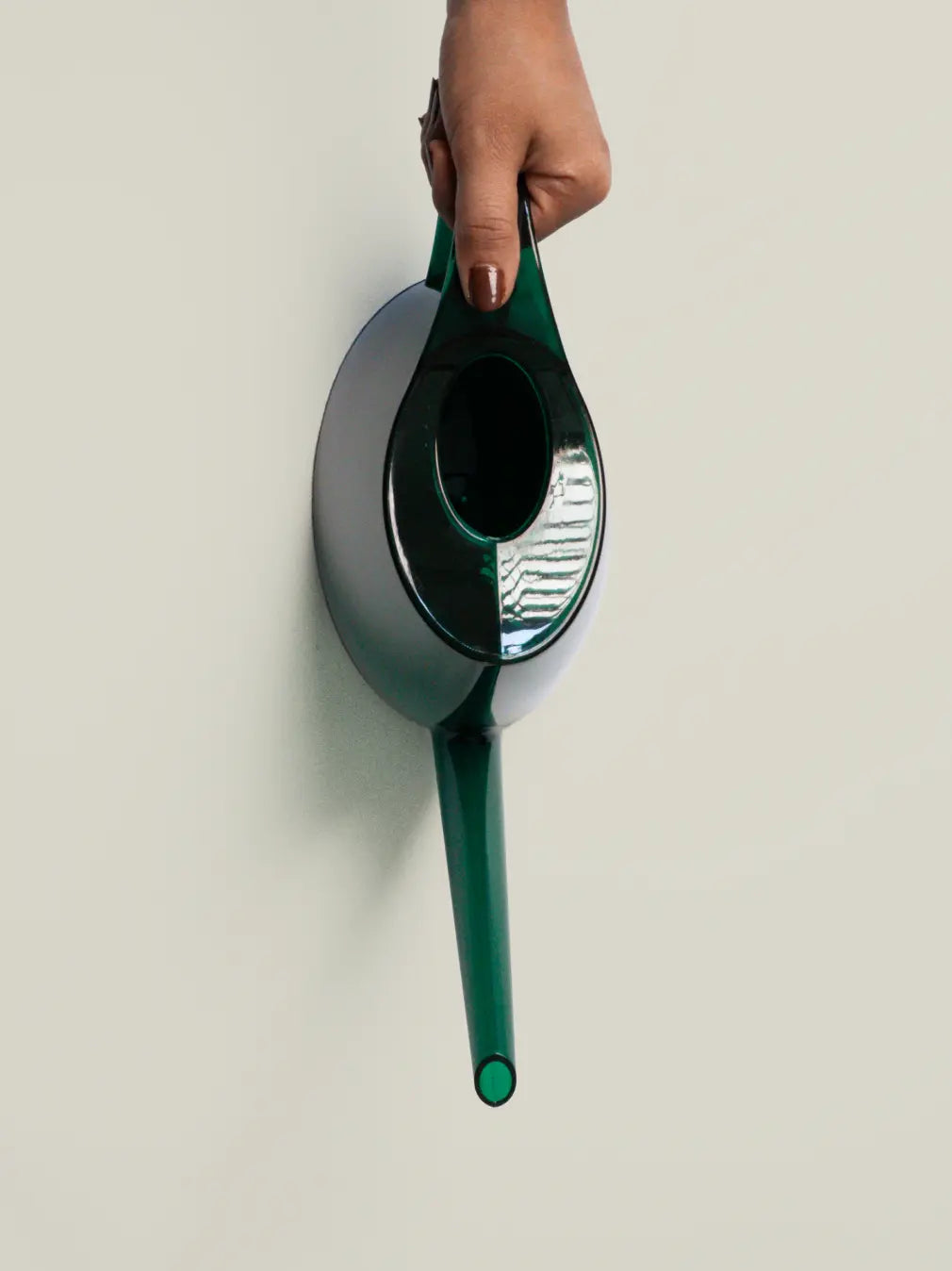 Green Willow Watering Can held from the top, showing long spout and modern ABS design.