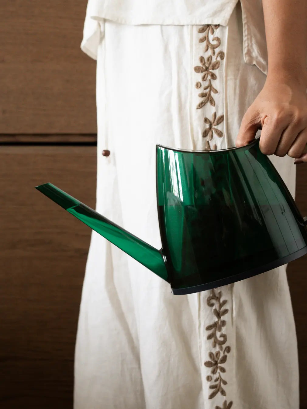 Willow Watering Can being carried, highlighting its lightweight ABS body and curved handle.
