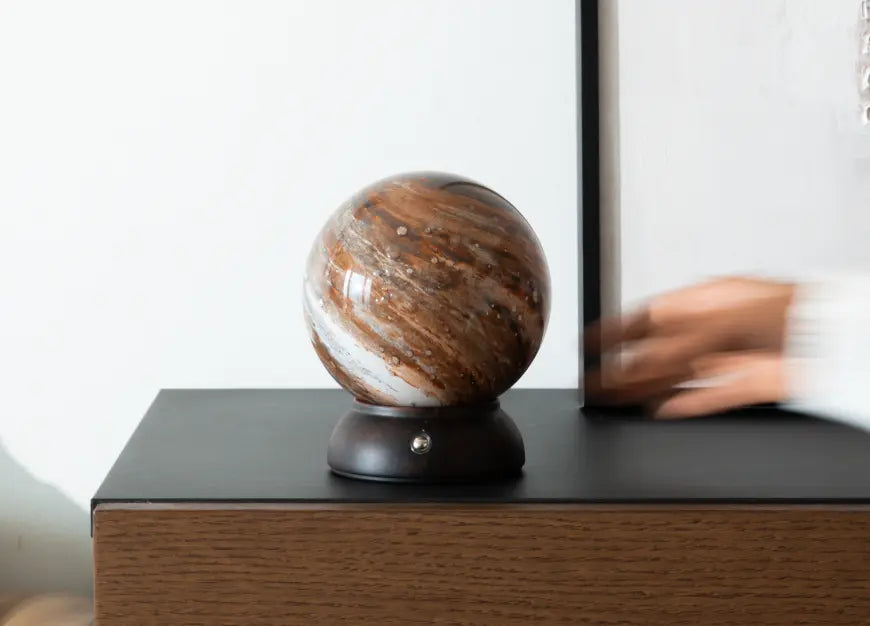 Cosmo glass portable table lamp displayed on a modern wooden side table