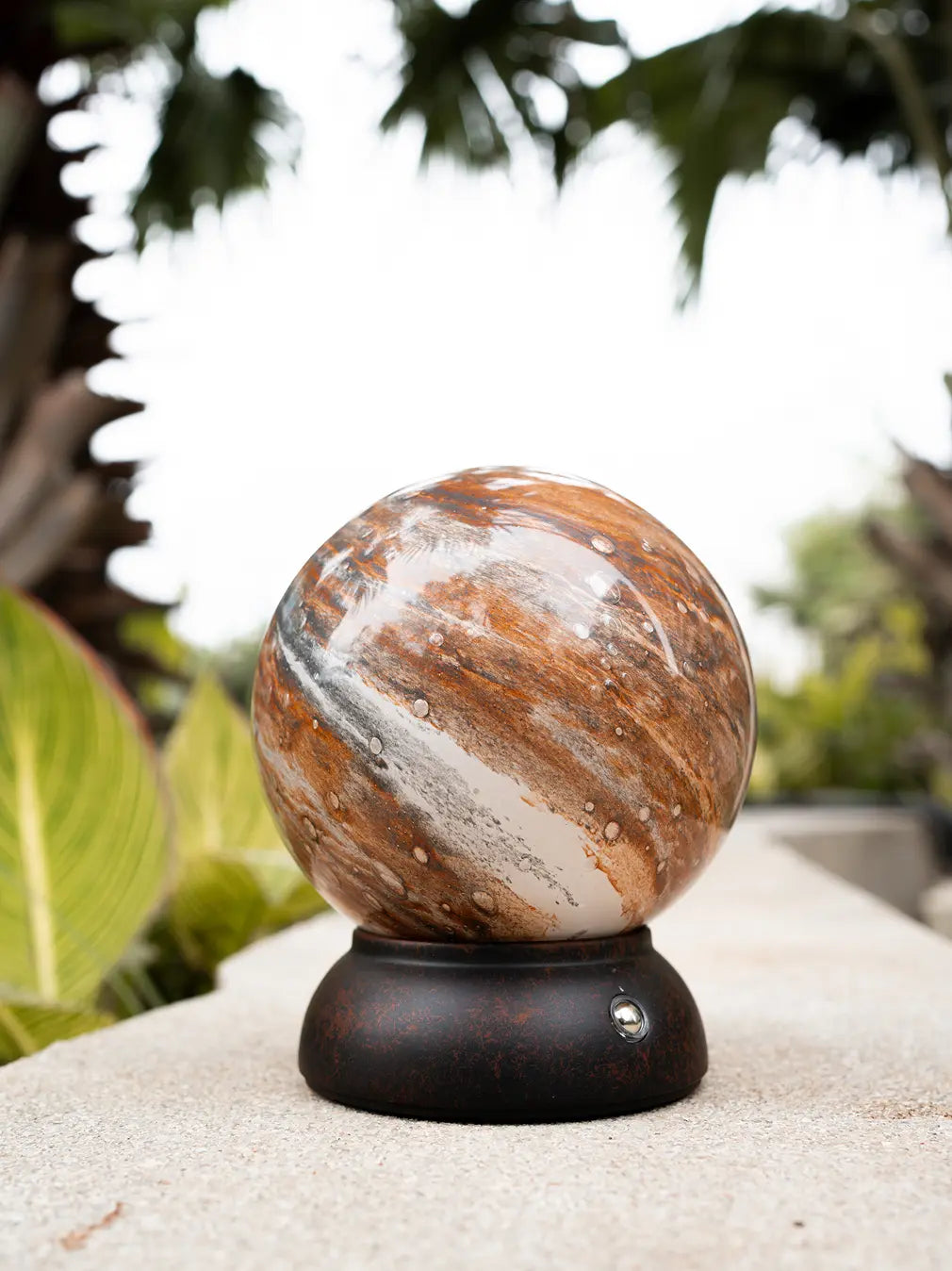 Cosmo glass portable table lamp styled outdoors with planet-inspired globe shade