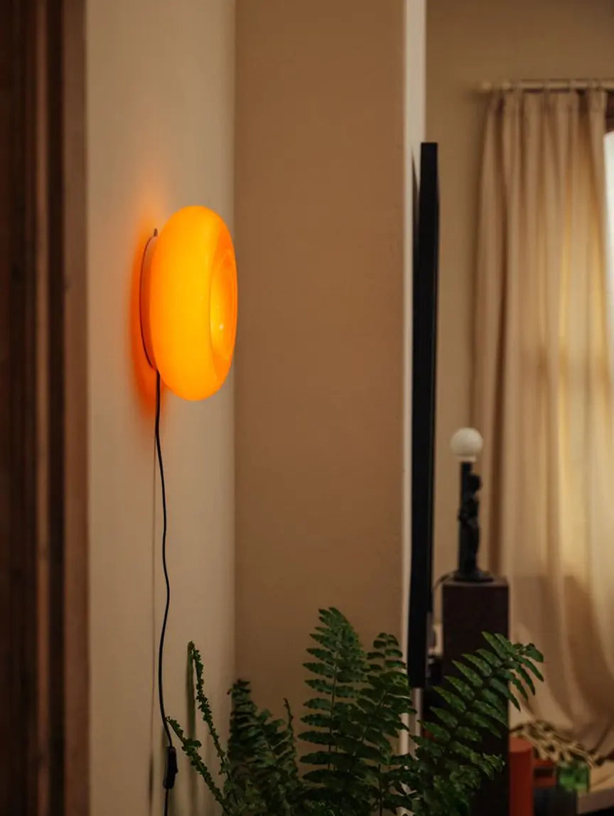 Donut Glass Lamp mounted on a wall, showcasing its dual functionality as a wall lamp and table lamp.
