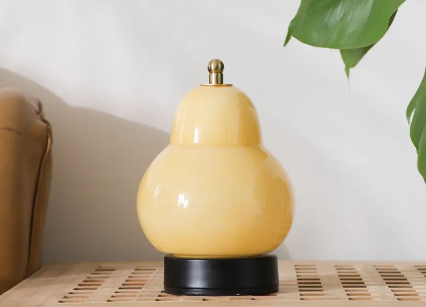 Pear Table Lamp featuring a pear-shaped glass body, black base and brass touch switch